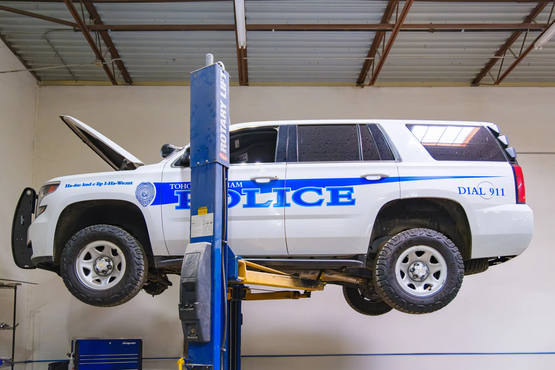 Fleet police vehicle on rotary lift