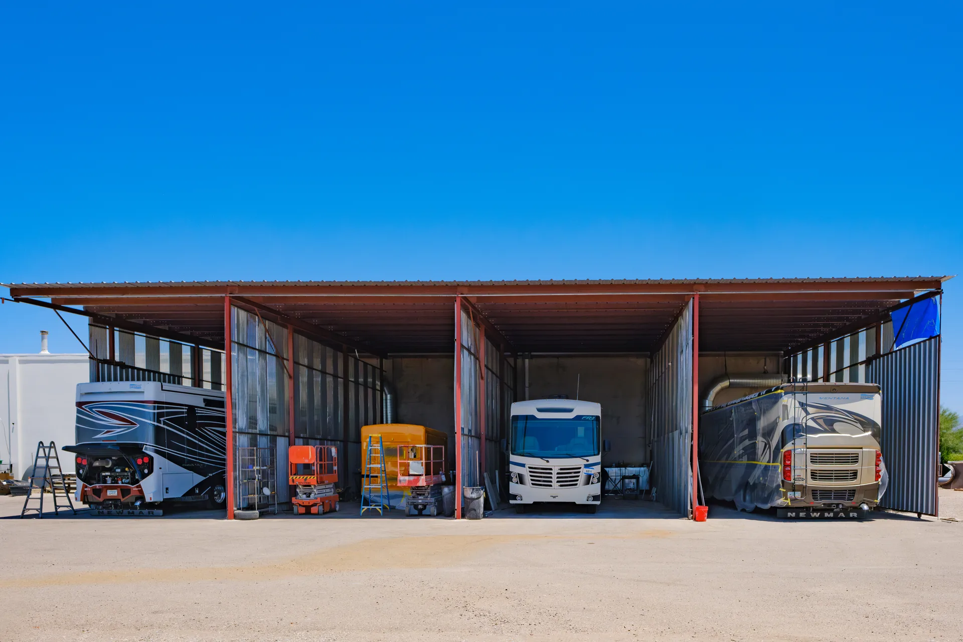 Large vehicle repair bays with RVs and motorhomes