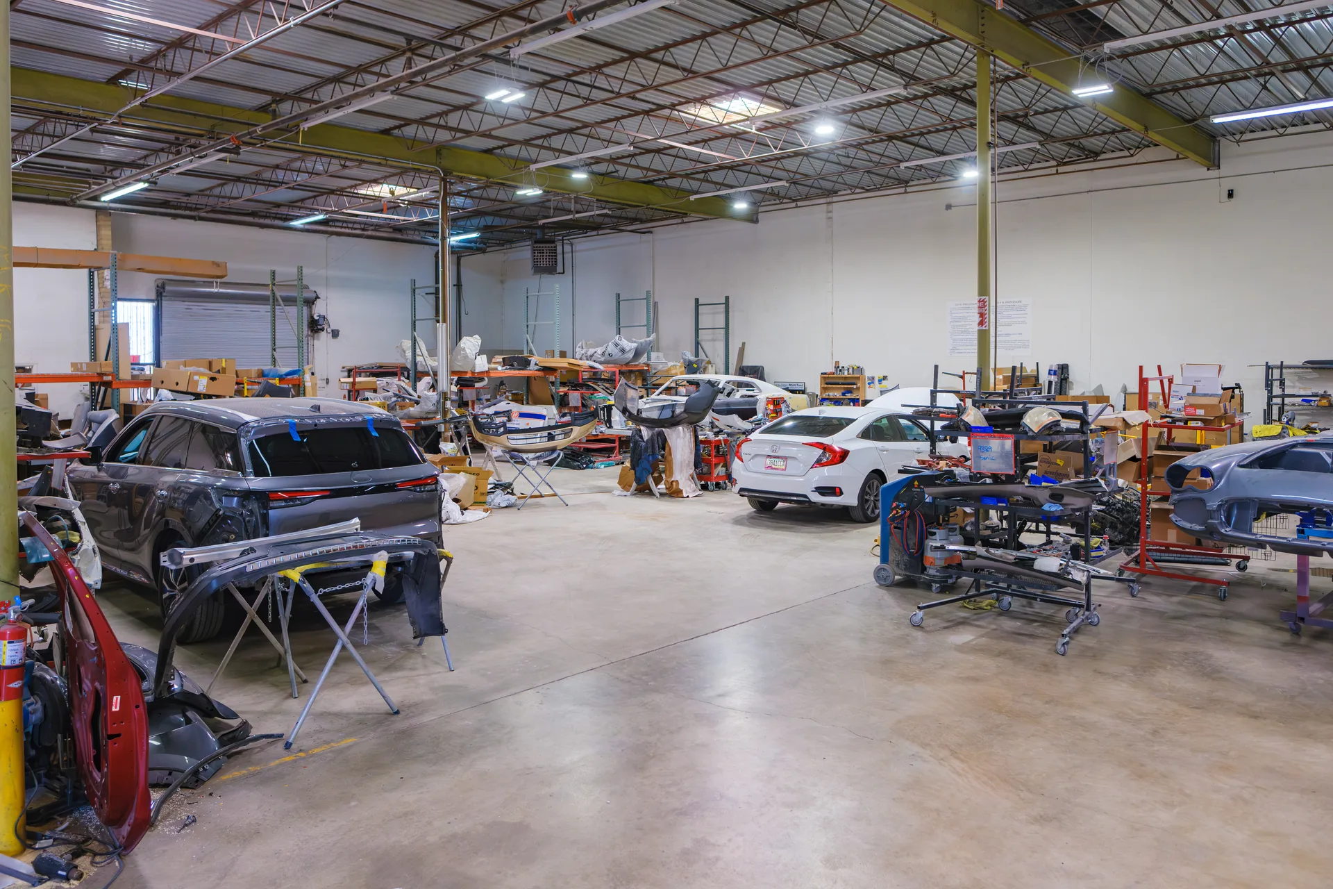 Multiple vehicles undergoing collision repair